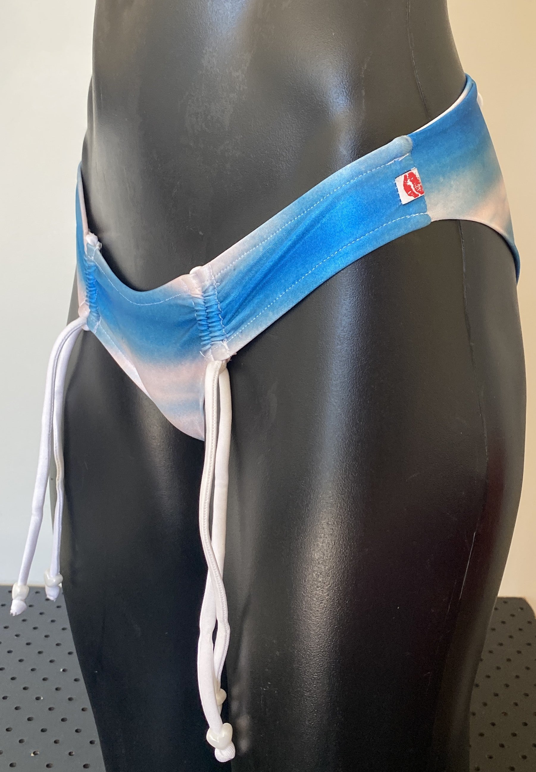 Side profile of MissManeater SHARKskin bikini pant showing logo detail and Brazilian cheeky fit, Australian made designer swimwear