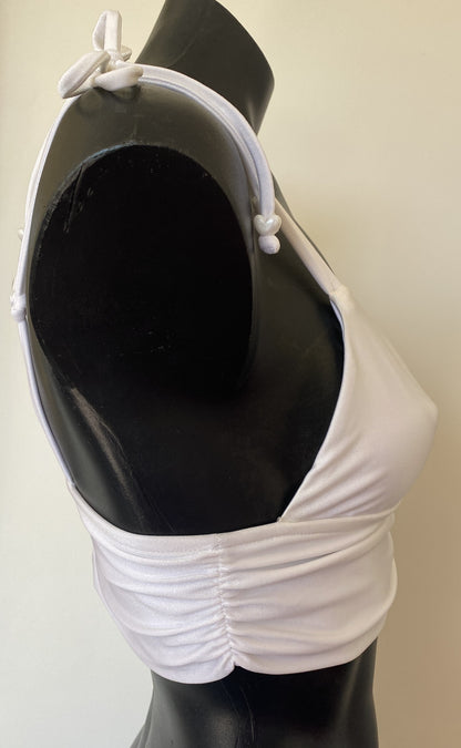 Side view of MissManeater white reef knot bralette bikini top on mannequin showing sculpted boutique fit