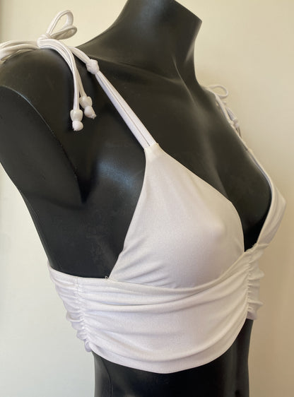 Close-up of MissManeater reef knot shoulder straps on white bralette bikini top