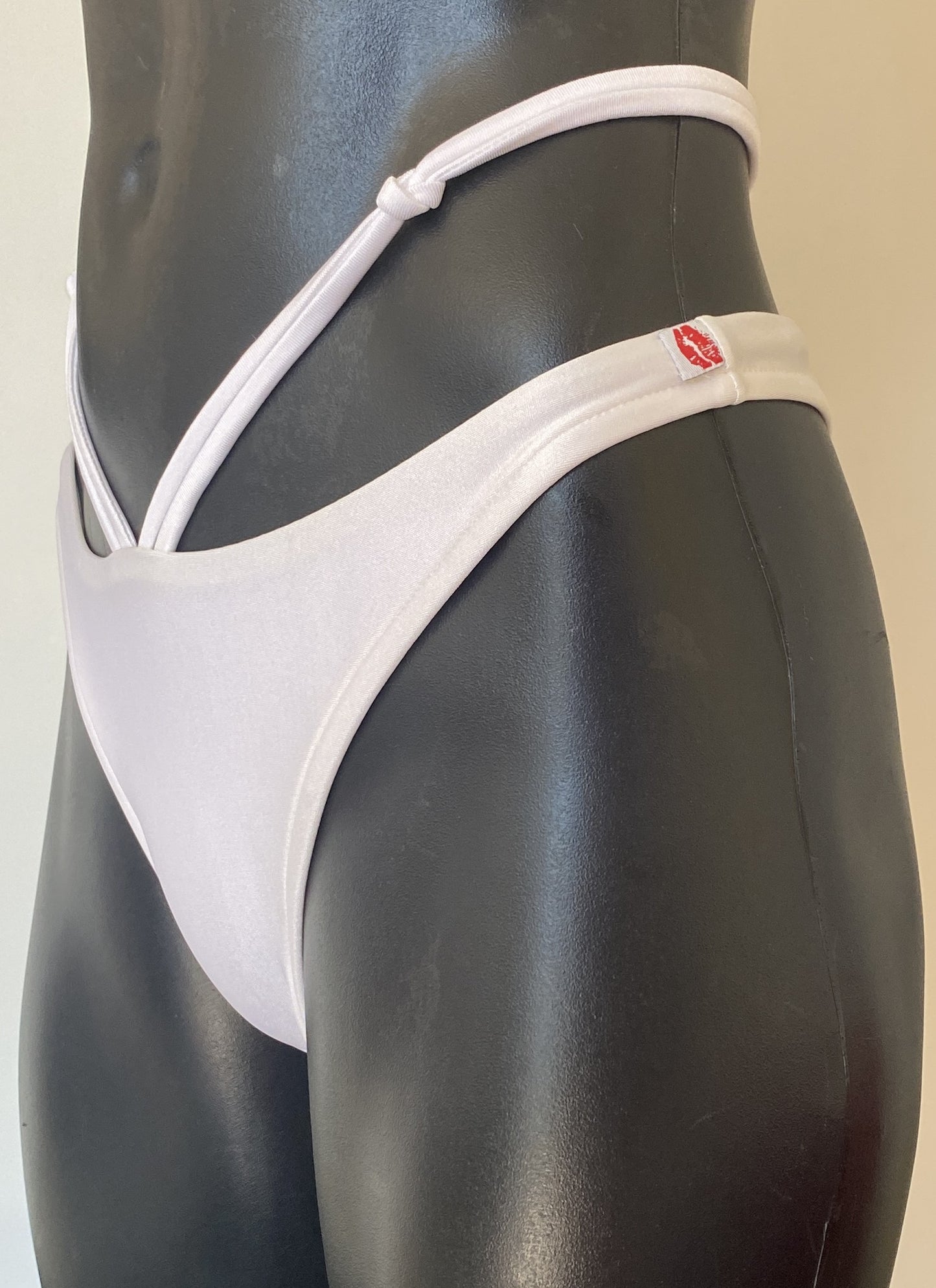 MissManeater white reefknot high cut bikini pant side view showing strap detail and Brazilian cut on mannequin Australian made designer swimwear