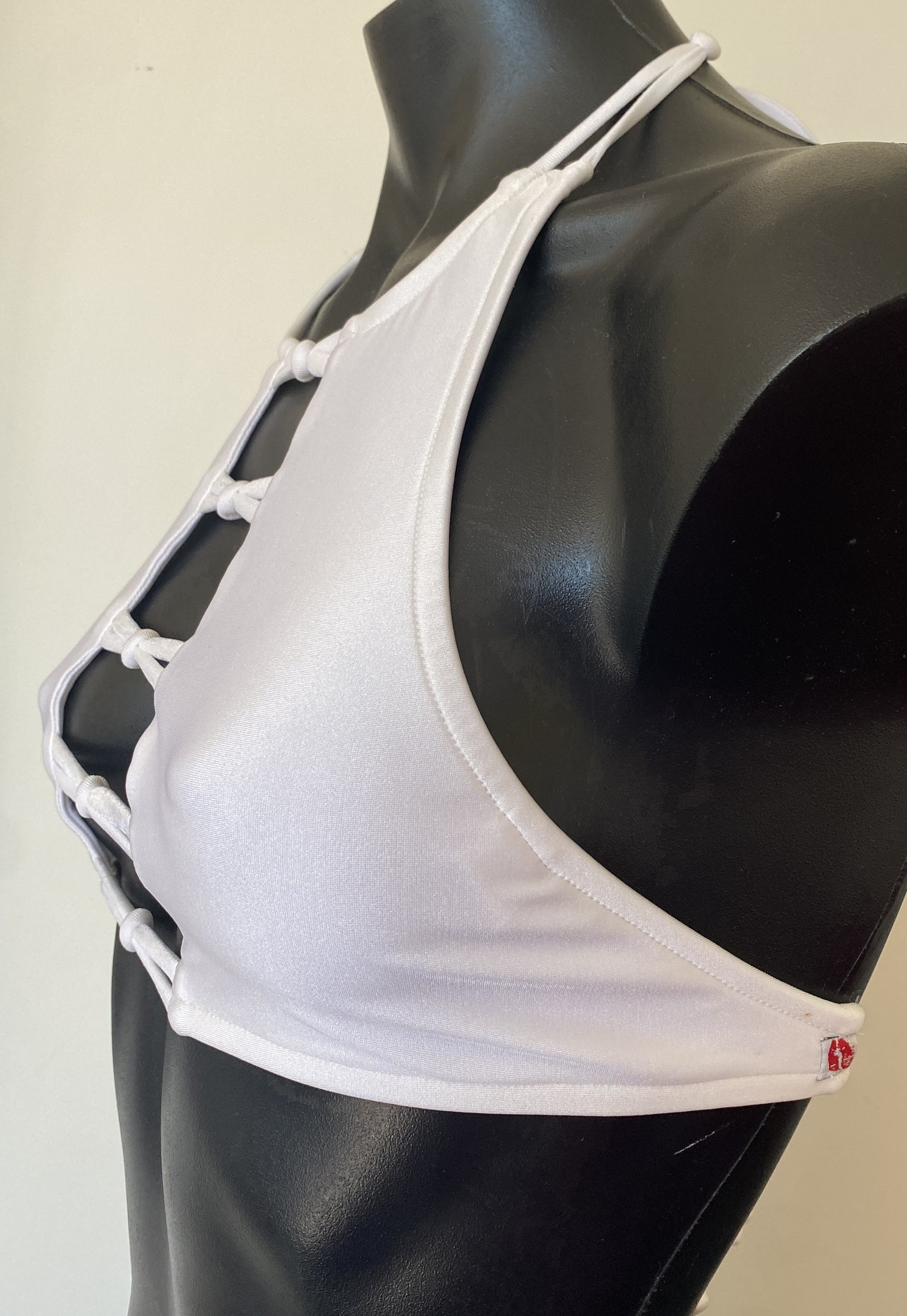 Side silhouette view highlighting the sculpted fit of the Miss Maneater white designer bikini crop top.